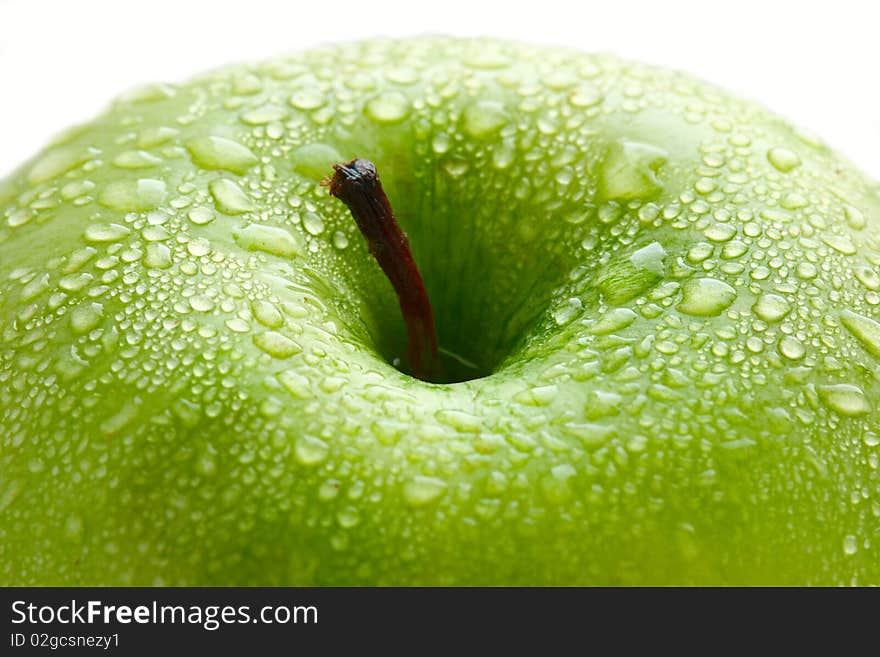 Water drops on ripe apple, macro closeup shot. Isolated over white.