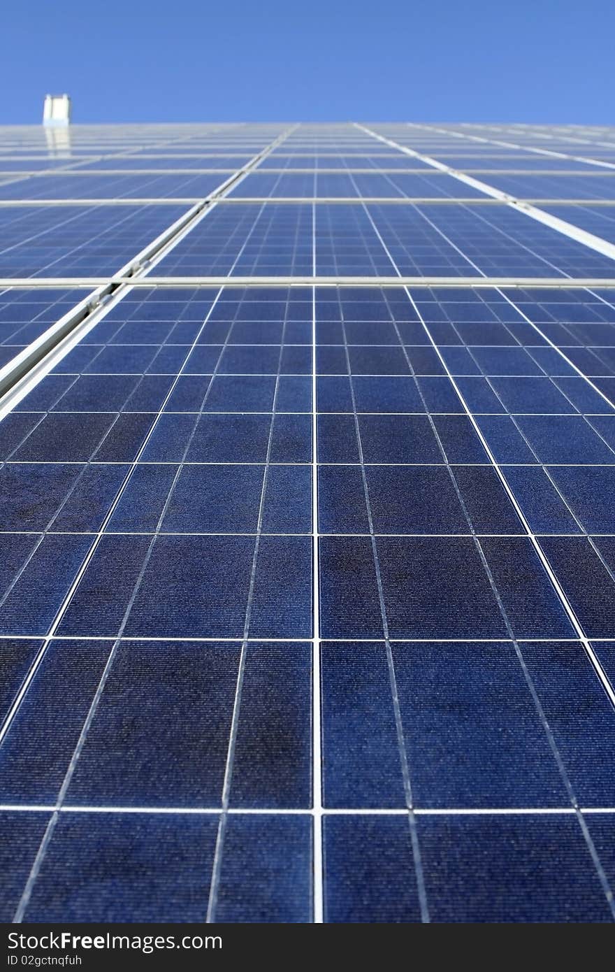 Modern solar photo voltaic panel close up with great blue cells details in a perspective view. Great for energy and environment themes.