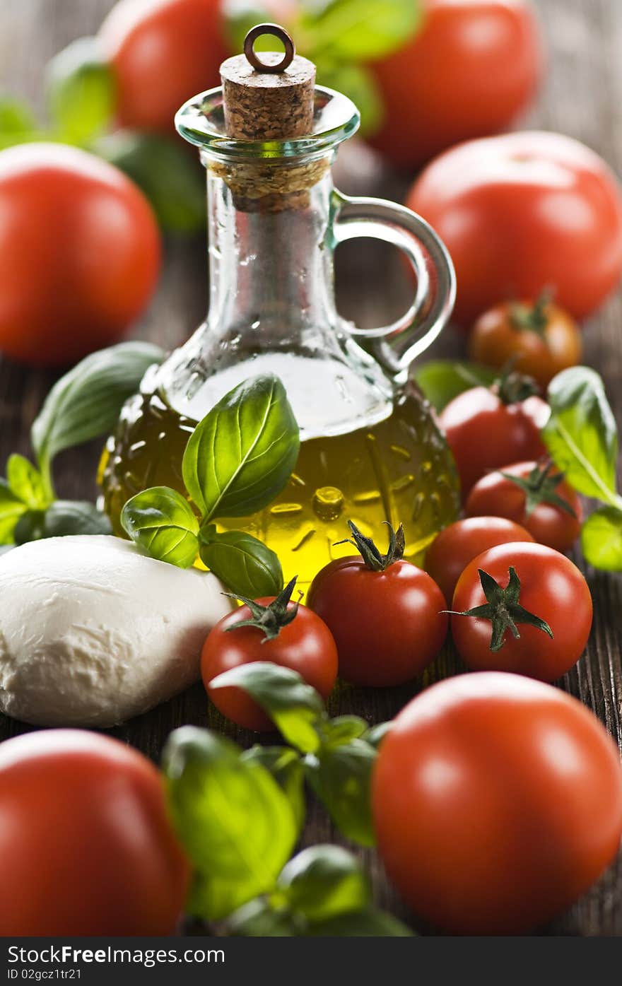 Mozzarella cheese, tomato, basil and olive oil background. Mozzarella cheese, tomato, basil and olive oil background