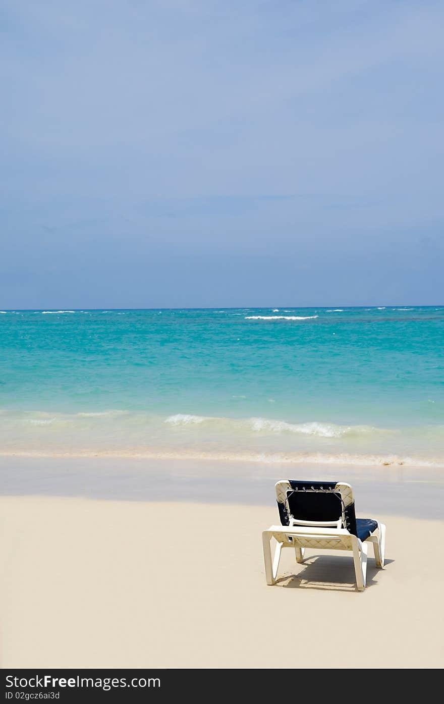 A sunbed near the water at exotic beach. Dominican Republic, Punta Cana.