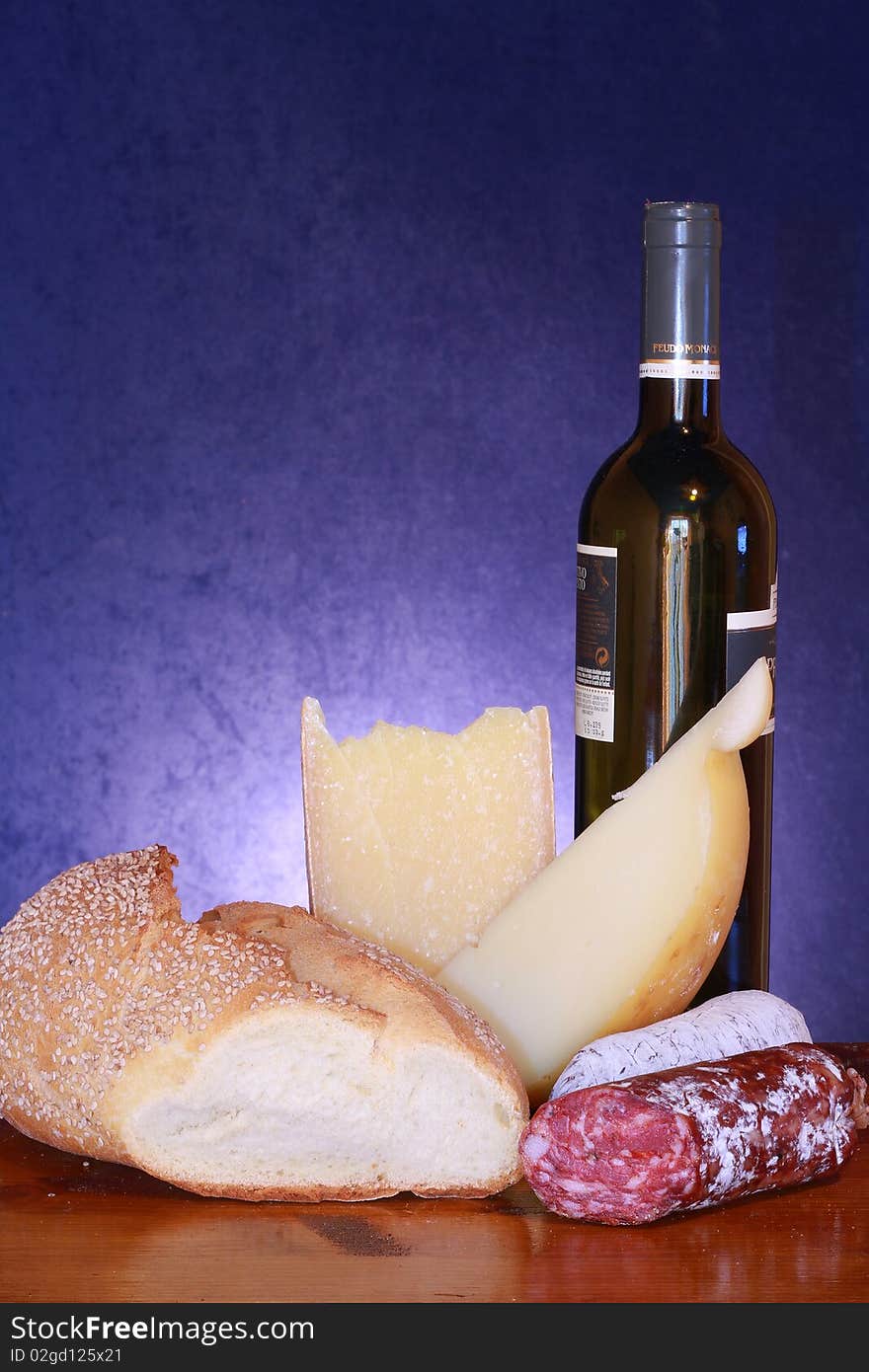 Composition of bread,   cheese and salami with bottle of wine. Composition of bread,   cheese and salami with bottle of wine