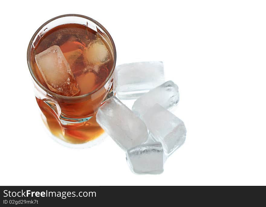 Glass of whiskey with ice cubes on white background with reverberation