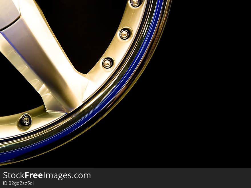 Metall gold wheel disc on a black background