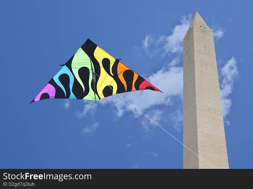 Colorful kite captured next to Washington Monument during the national kite festival.