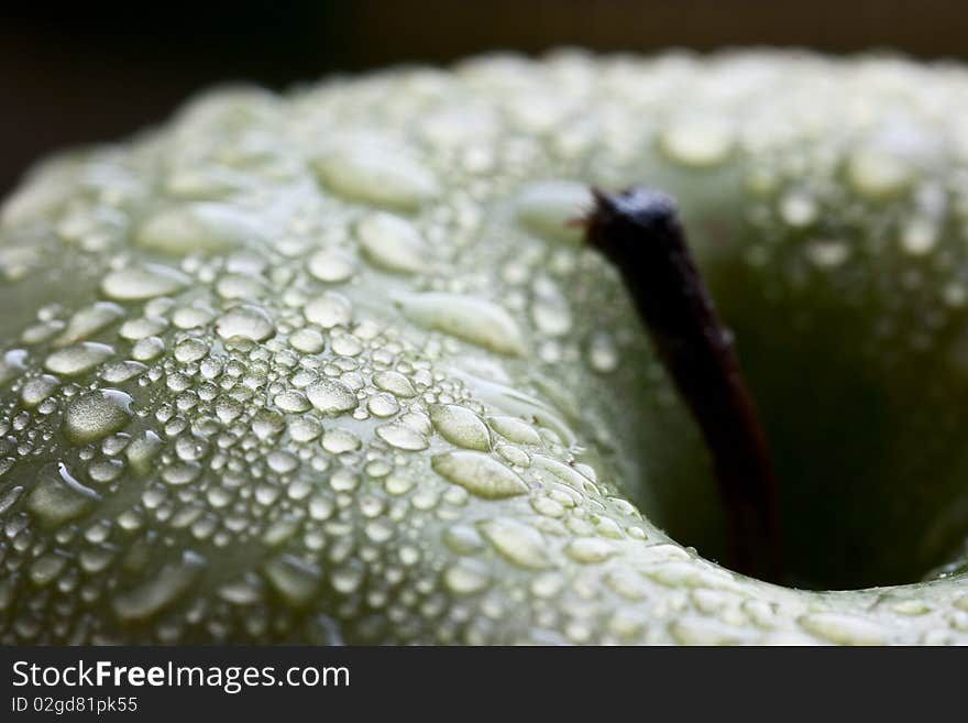 Water drops on ripe apple, macro closeup shot. low key technique. Water drops on ripe apple, macro closeup shot. low key technique.