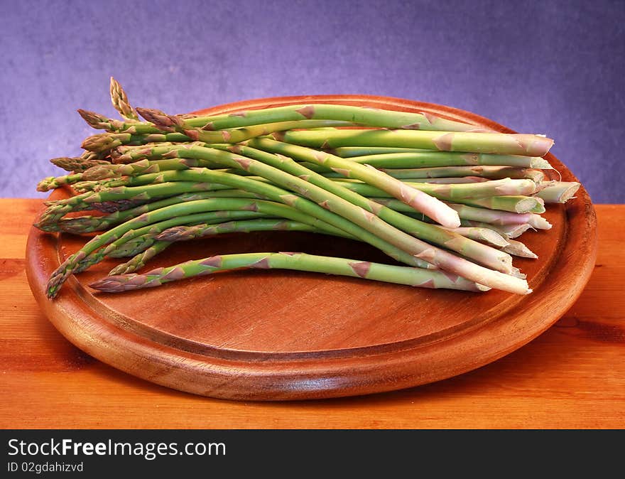 Some asparagus on wooden board