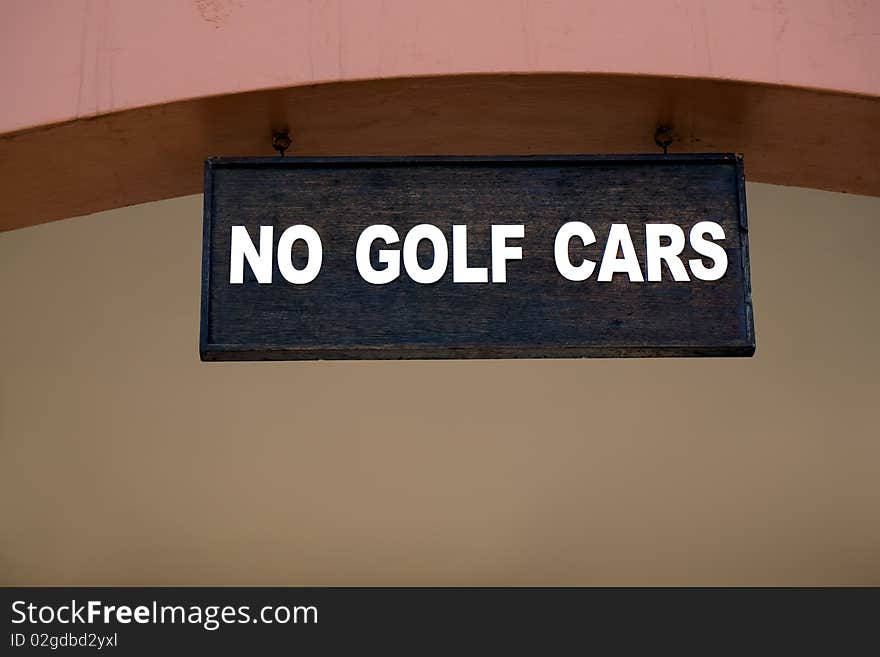 Black and white sign at a golf club displaying no golf cars. Black and white sign at a golf club displaying no golf cars.