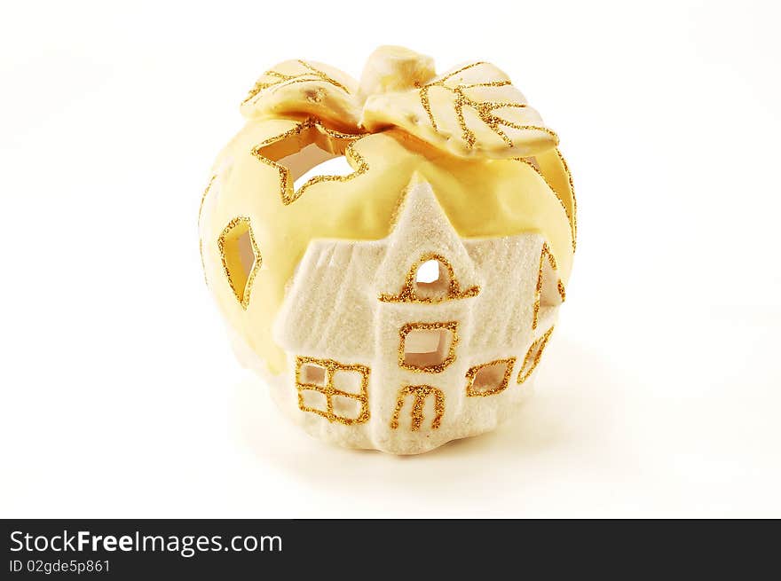 Aroma lamp in the form of winter house is isolated on a white background. Aroma lamp in the form of winter house is isolated on a white background