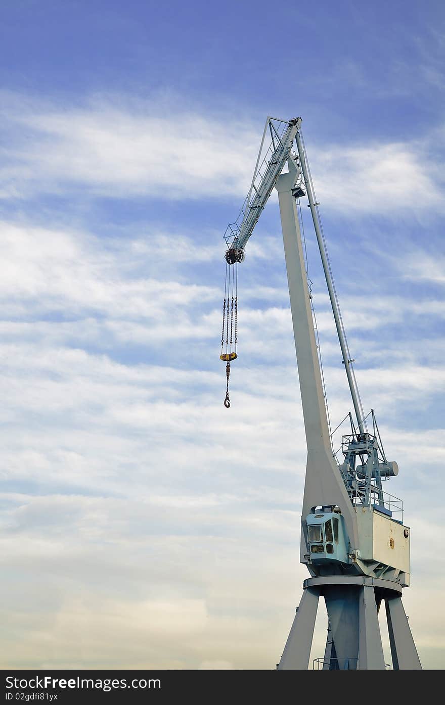 Port crane with blue sky and come clouds