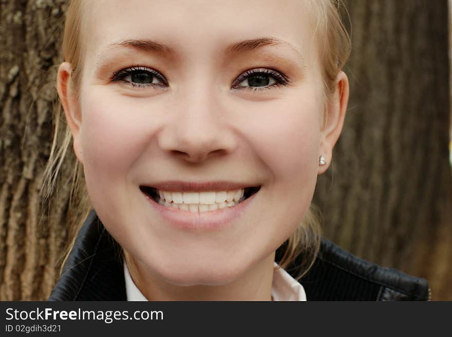 Portait of young beautiful smiling woman, outdoor shot