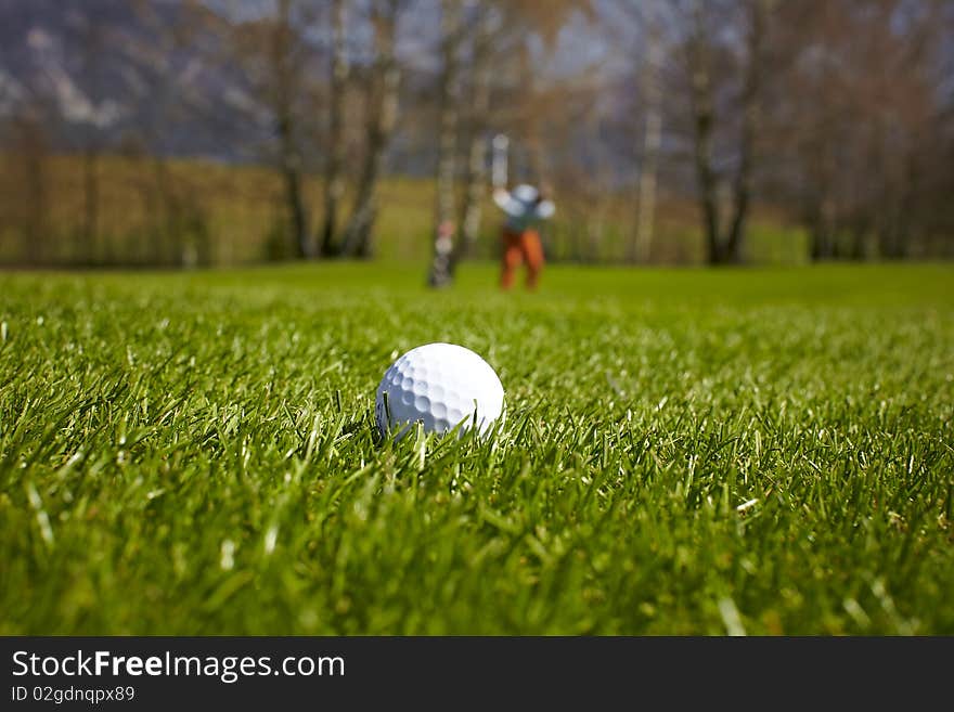 Golf ball close-up with golfer man