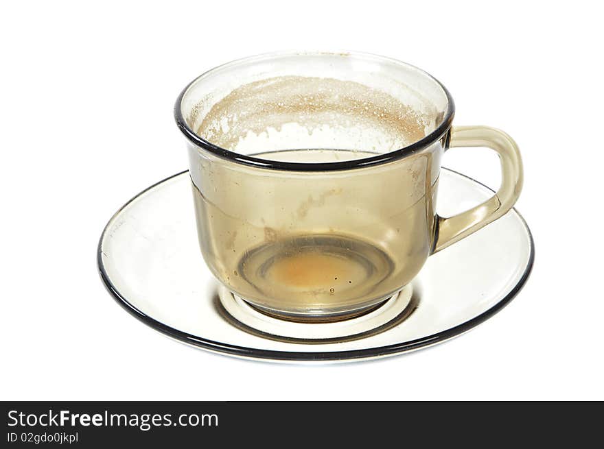 Dirty transparent coffee cup on saucer on white background. Dirty transparent coffee cup on saucer on white background