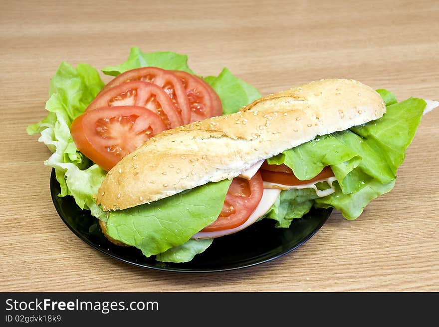 Delicious and fresh sesame baguette with turkey, cheese, lettuce and tomatoes. Delicious and fresh sesame baguette with turkey, cheese, lettuce and tomatoes