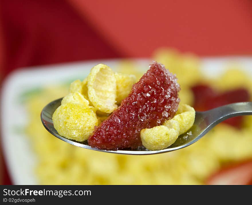 Macro on a spoon full of cereals with strawberries. Macro on a spoon full of cereals with strawberries