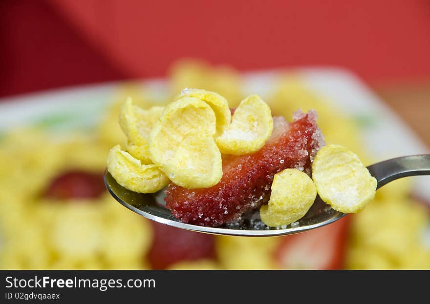 Macro on a spoon full of cereals with strawberries. Macro on a spoon full of cereals with strawberries