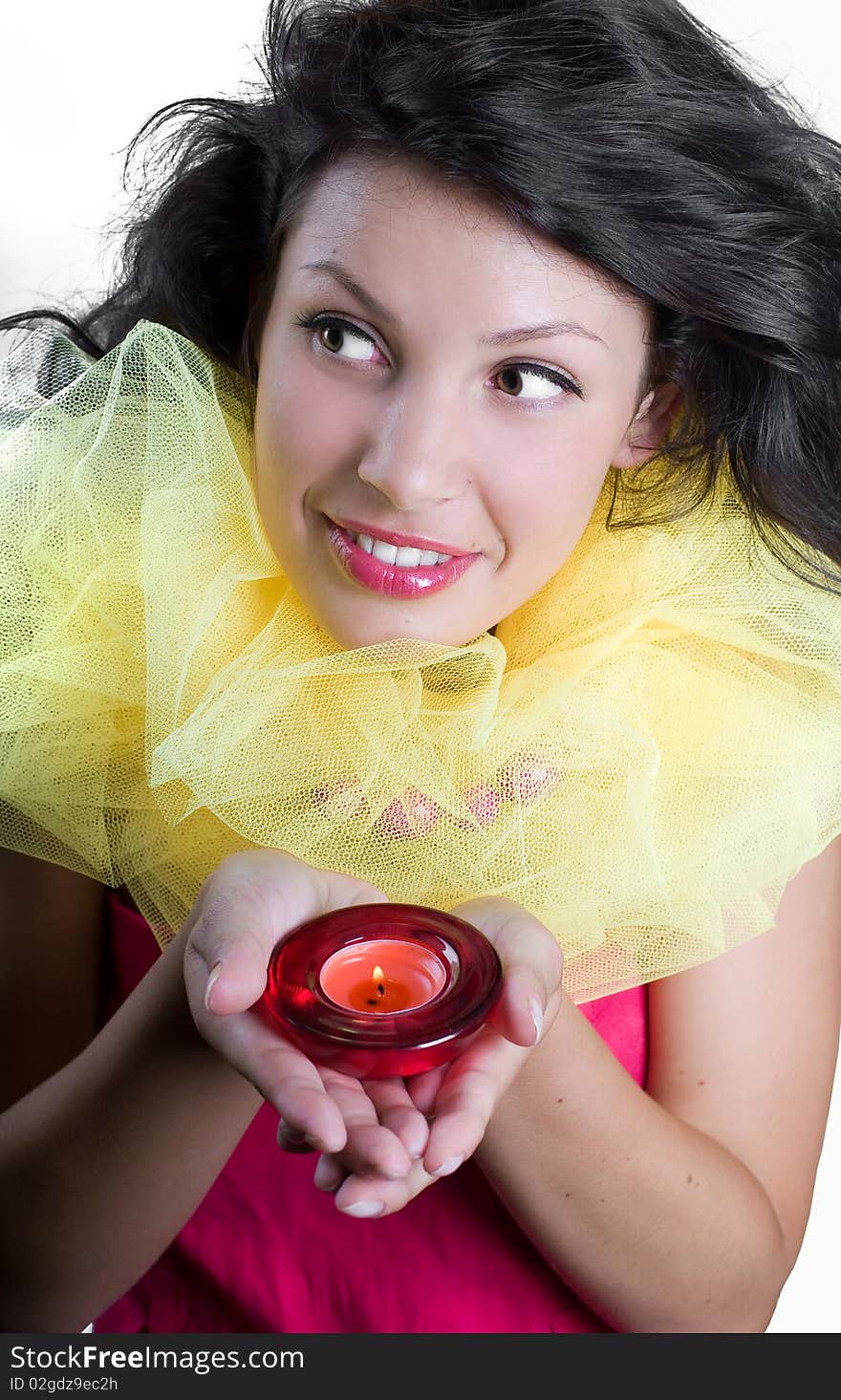 Beautiful happy girl with candles in hands