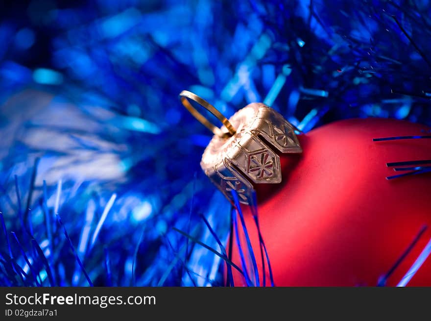 Beautiful red bauble on blue christmas decoration