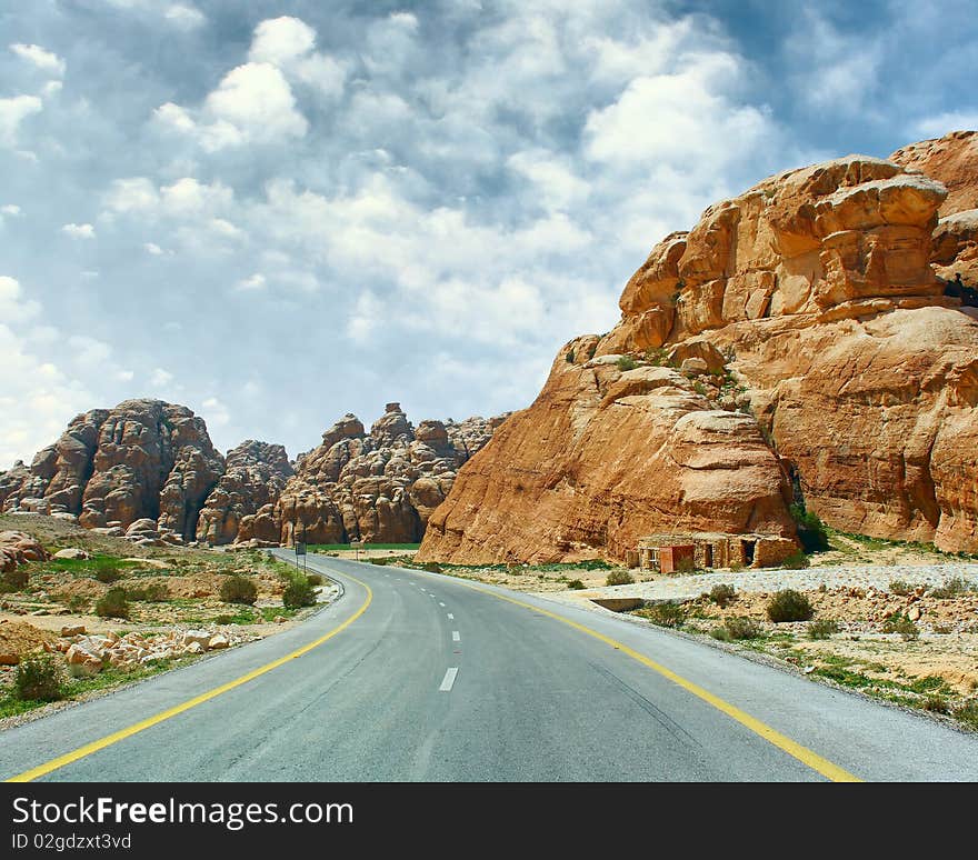 Asphalt road blue sky with clouds and mountains