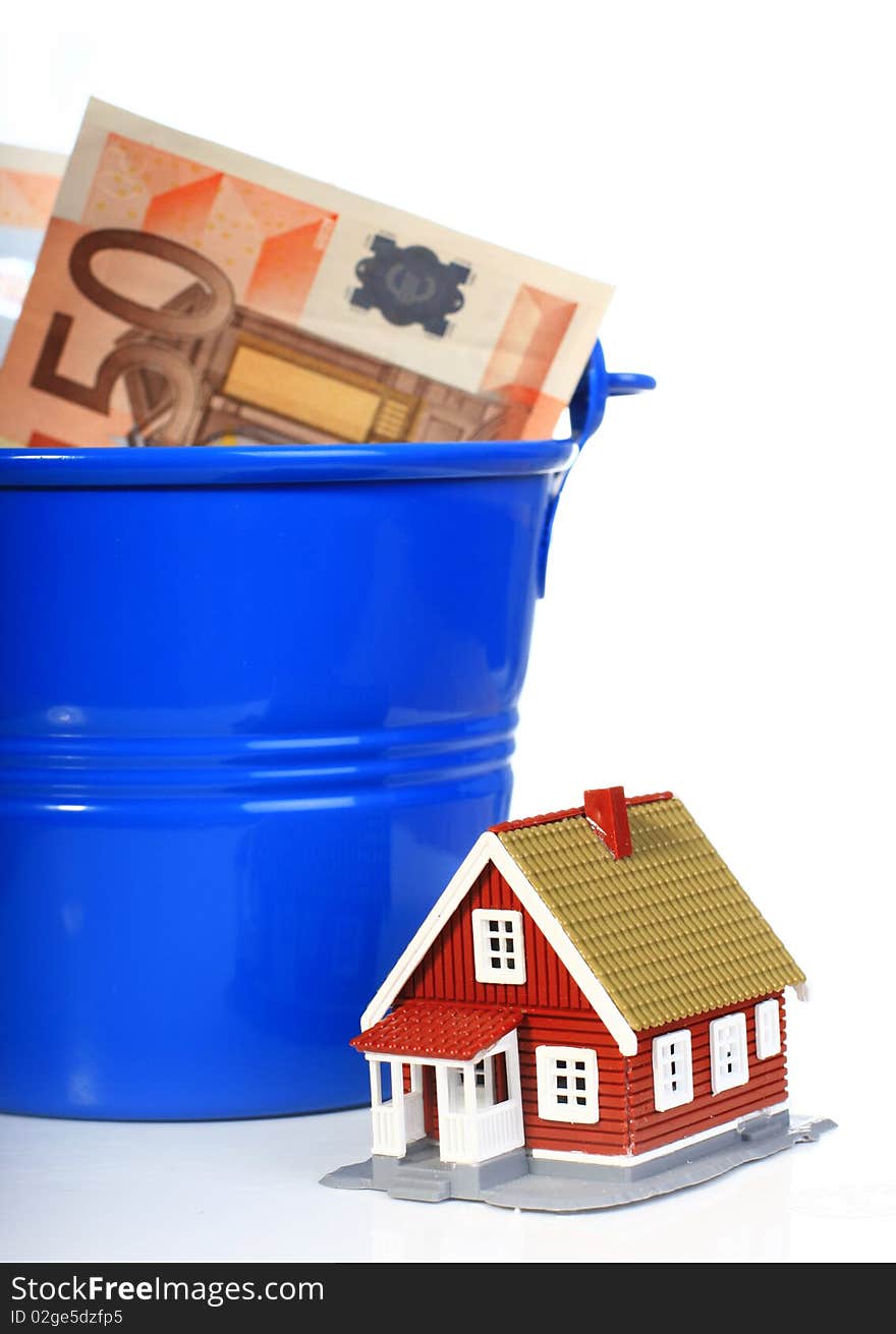 House, european money inside the bucket isolated over white. House, european money inside the bucket isolated over white.