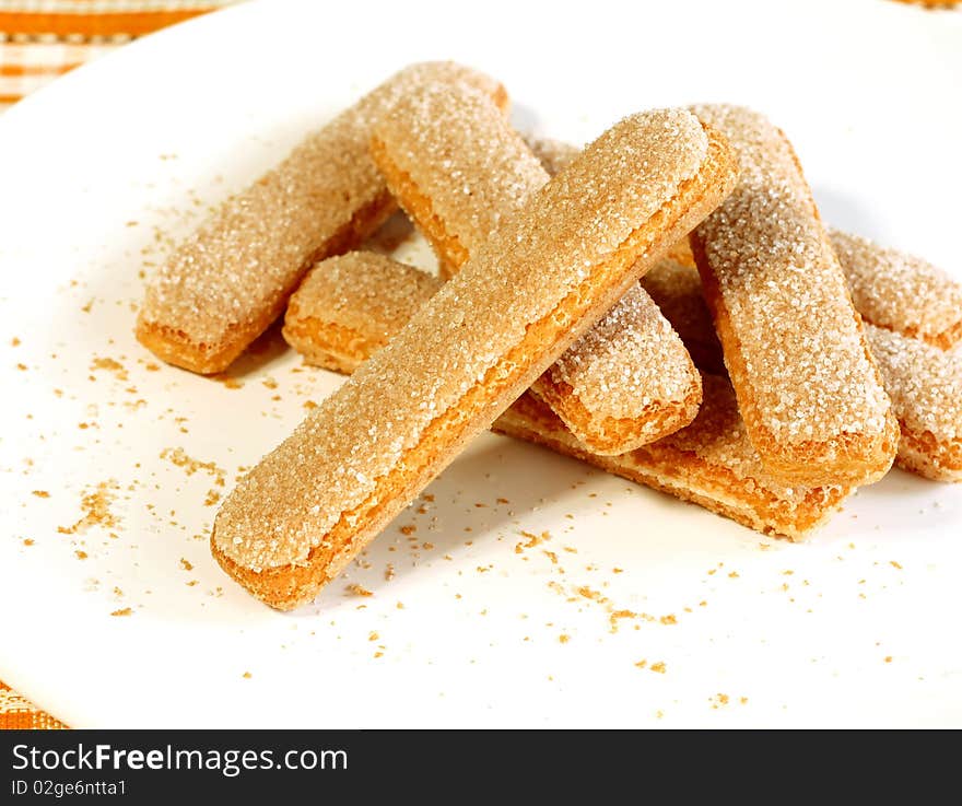 Cookies strewed by sugar on white plate