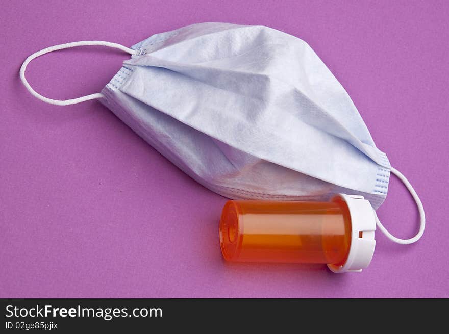 Surgical mask and prescription bottle for a health care themed image. Surgical mask and prescription bottle for a health care themed image.