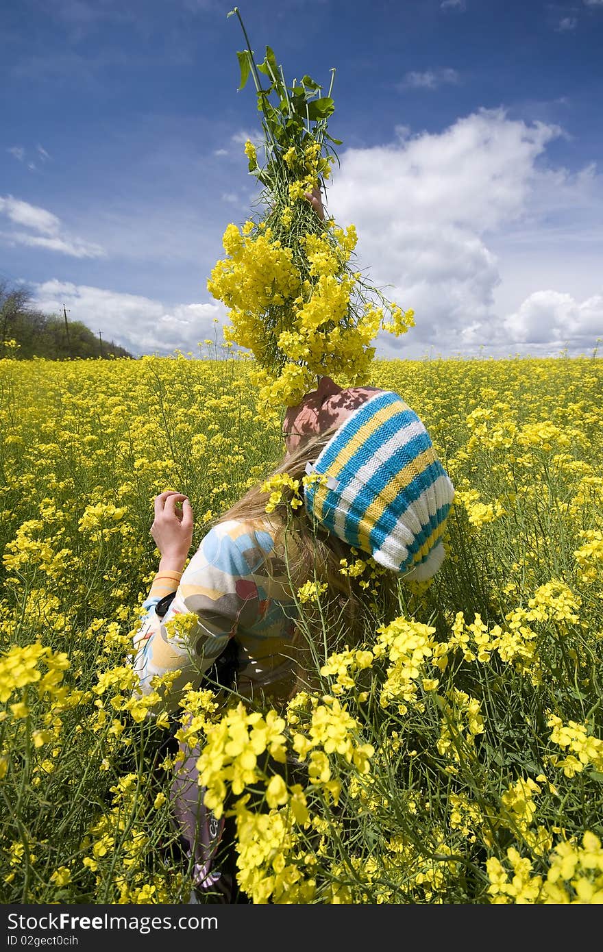 The girl on a background of yellow flowers. The girl on a background of yellow flowers