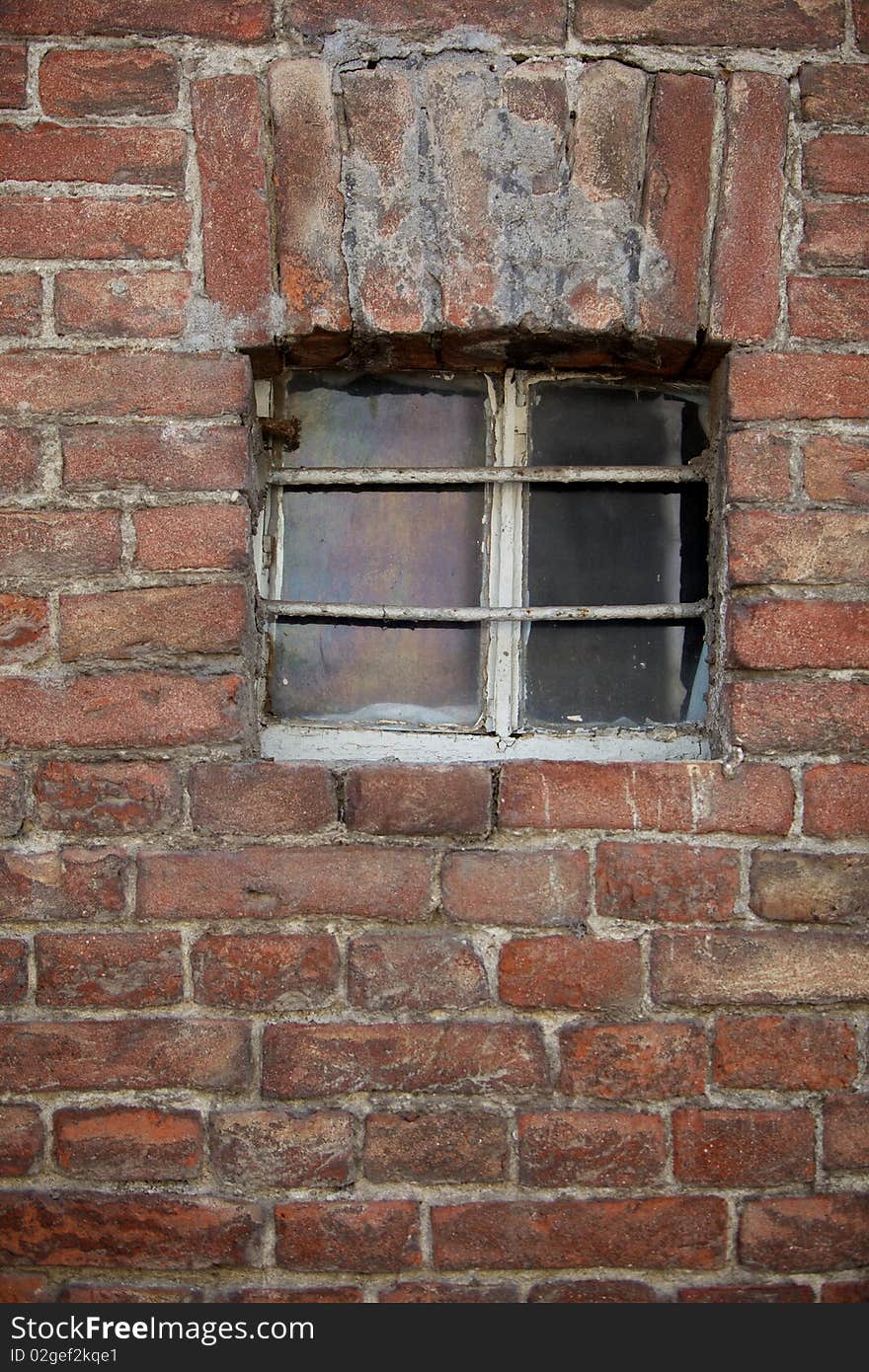 A little window in a brick wall of a typical old Italian house. A little window in a brick wall of a typical old Italian house.