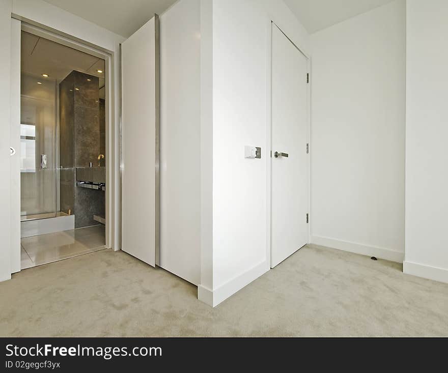 Modern bedroom with walk-in wardrobe and en-suite bathroom. Modern bedroom with walk-in wardrobe and en-suite bathroom