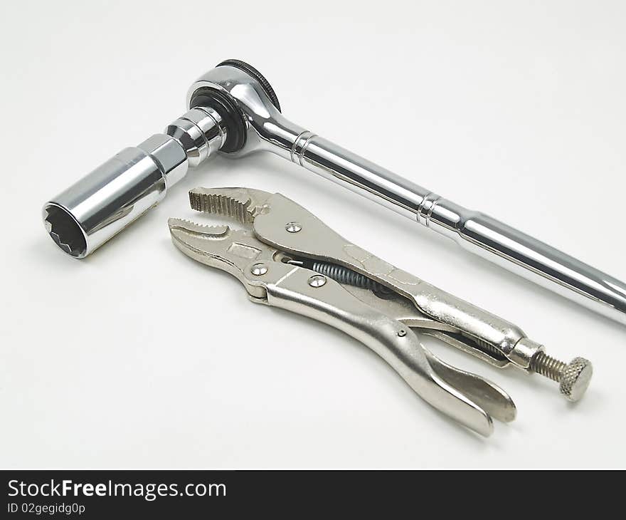 Studio shot of spark plug socket and locking pliers on white background. Studio shot of spark plug socket and locking pliers on white background