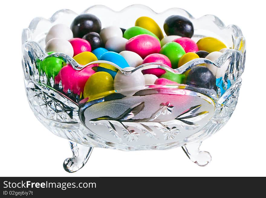 Vase with colour sweets on a white background