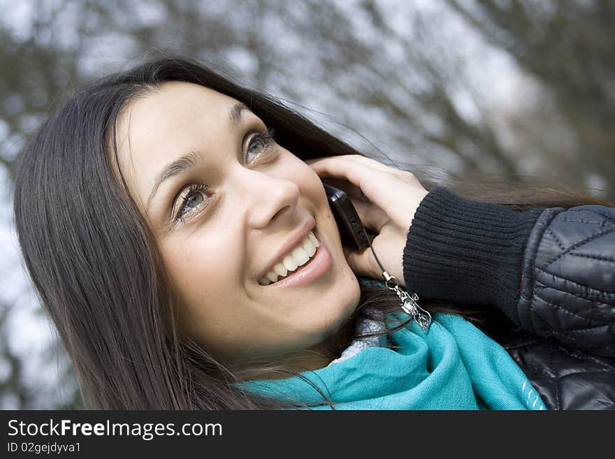 Young beautiful woman on the phone in the park. Young beautiful woman on the phone in the park