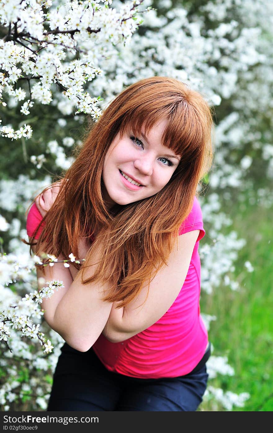 Redheaded Girl In Blossom Garden