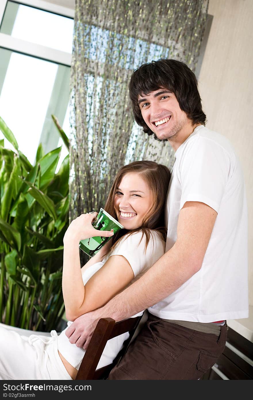 Girl with green cup and boy with smile