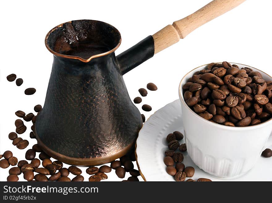 Pot of hot black coffee and cup with beans