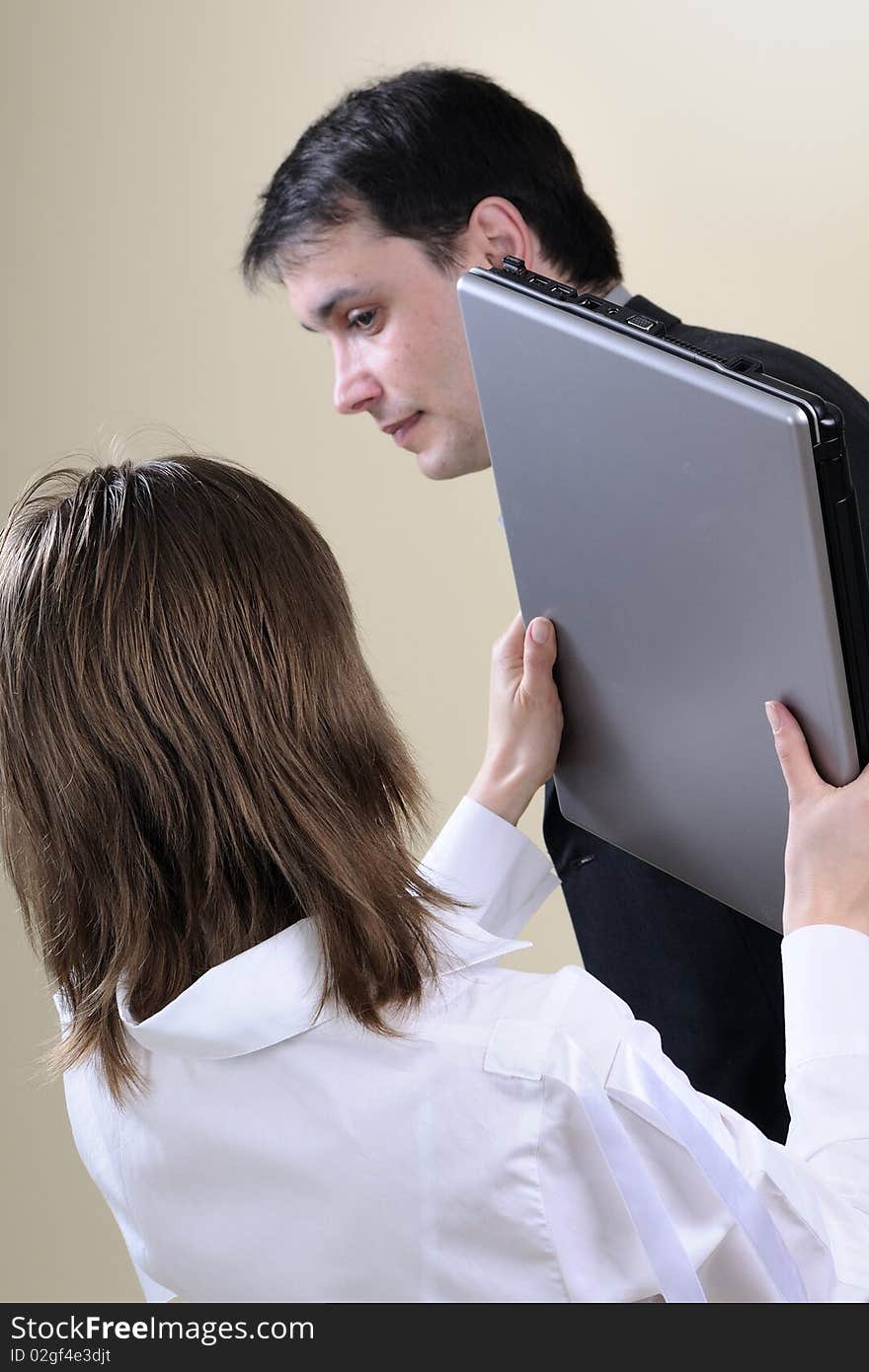 White woman hitting man with office equipment