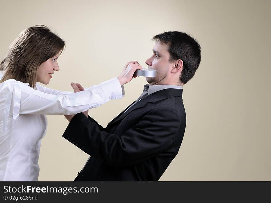 White business woman gluing his partner mouth in office. White business woman gluing his partner mouth in office