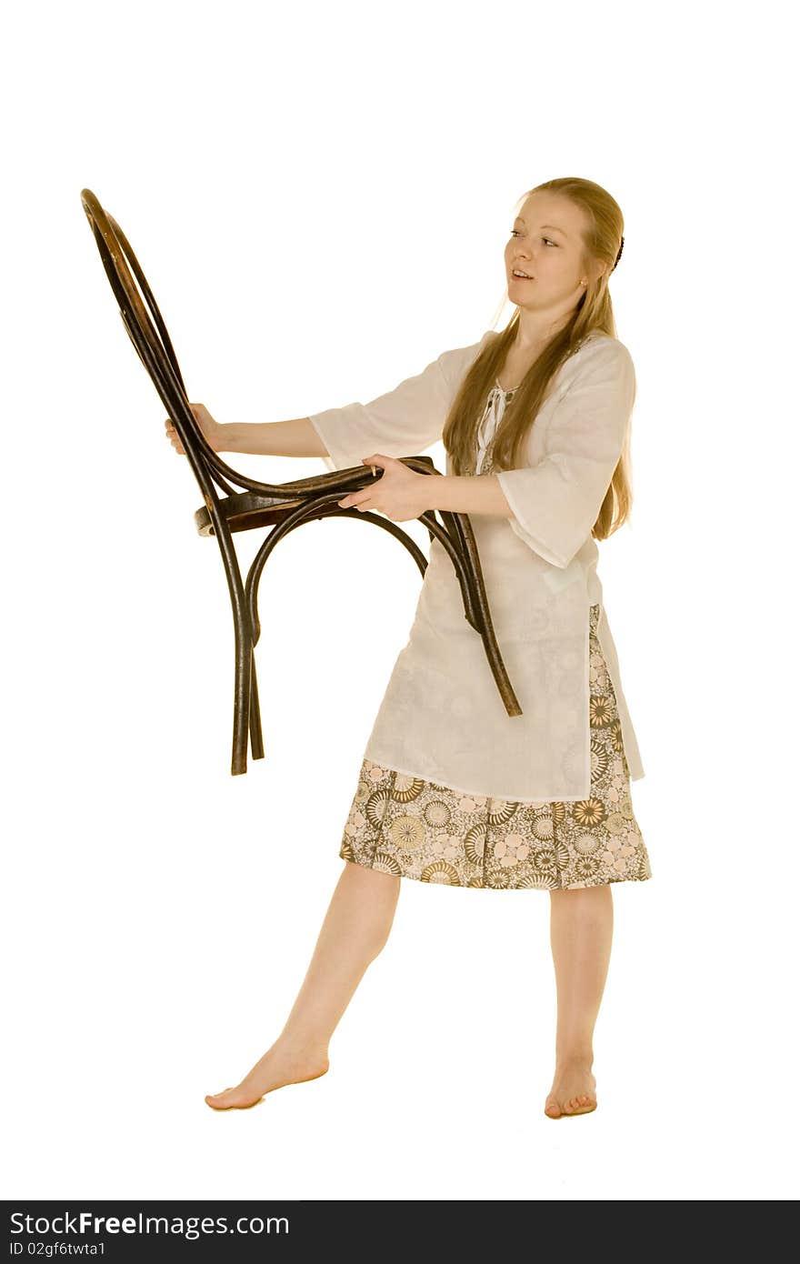 Young woman holding a chair on a white background