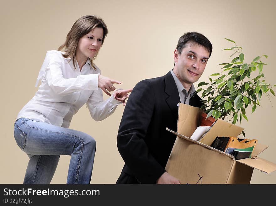 Upset fired man holding box with pland and documents and his boss firing him. Upset fired man holding box with pland and documents and his boss firing him