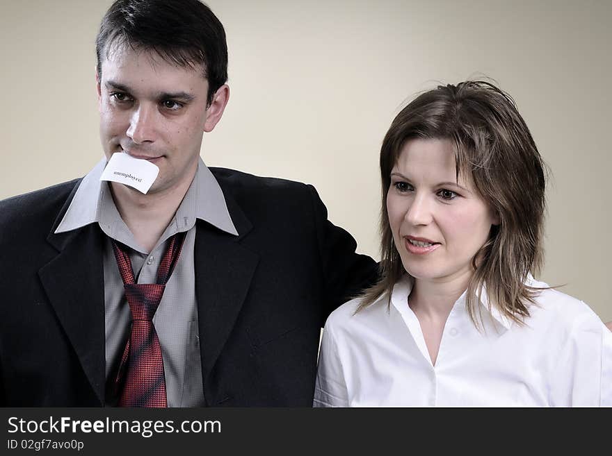 White man and woman holding in mouth papers with fired words. White man and woman holding in mouth papers with fired words