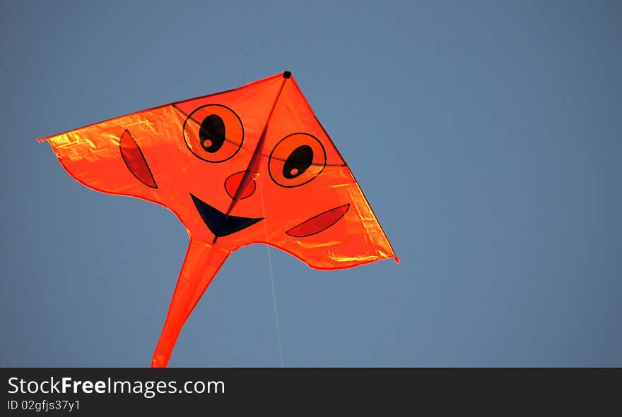 Smiling Kite With A Blue Sky Background