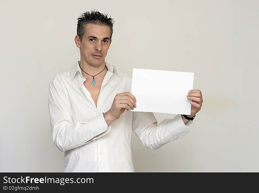 Man in white shirt holding a sign with white text. Man in white shirt holding a sign with white text