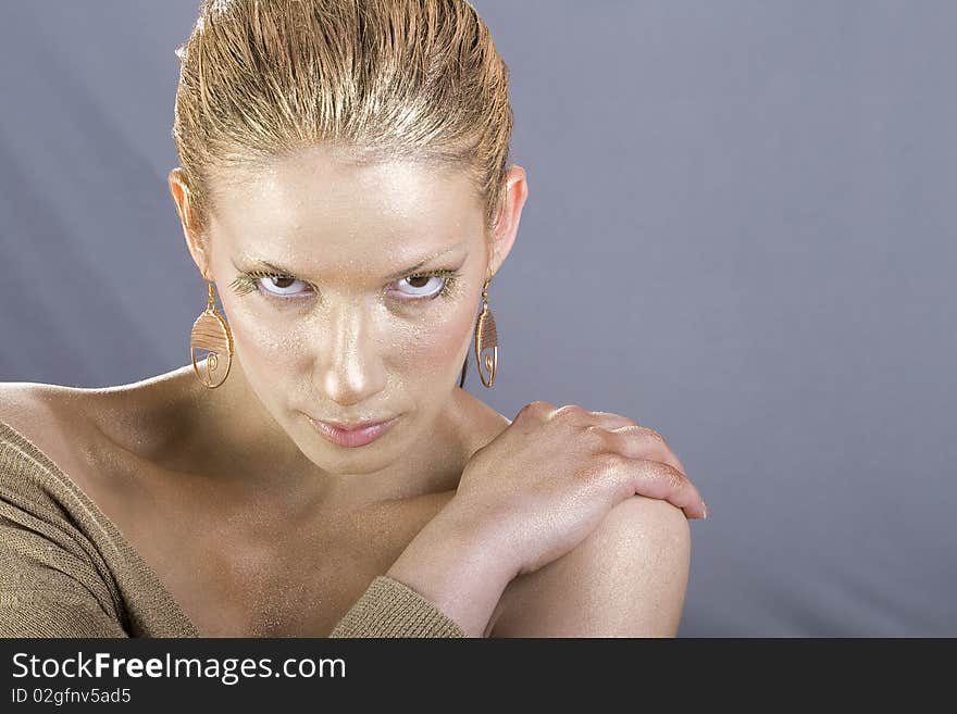 Beautiful woman with golden make up - Close up portrait of a beautiful female model. Beautiful woman with golden make up - Close up portrait of a beautiful female model