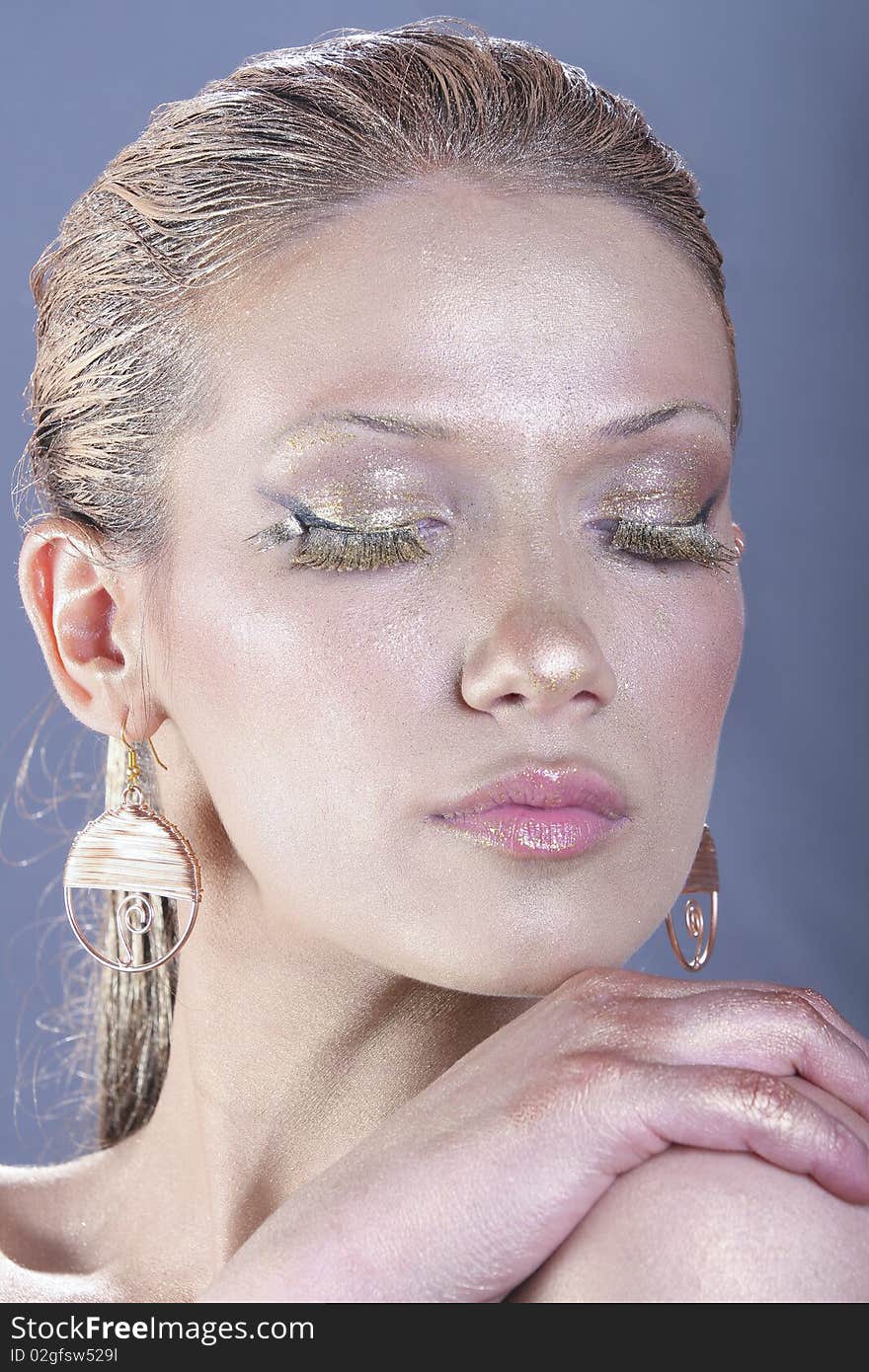 Beautiful woman with golden make up - Close up portrait of a beautiful female model. Beautiful woman with golden make up - Close up portrait of a beautiful female model