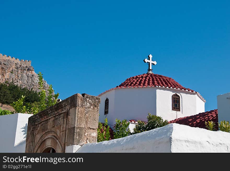 Greek church in santorini greece with a cross