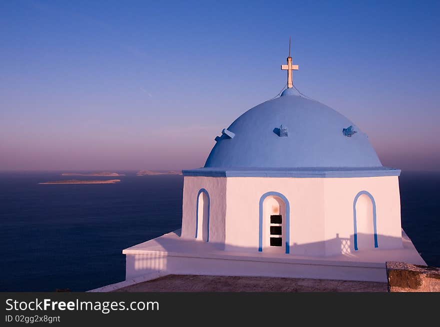 Greek church in santorini greece with a cross