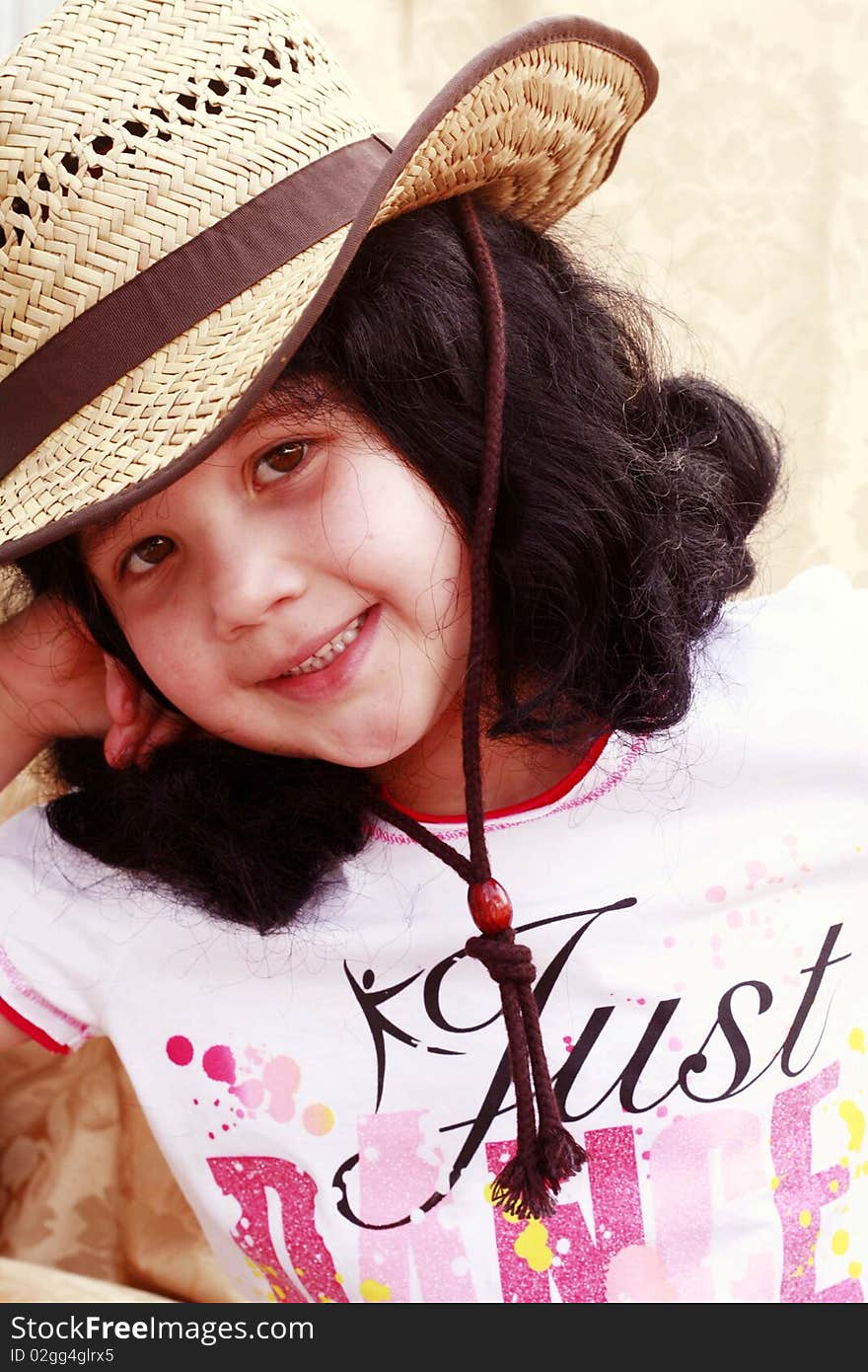 Little girl wearing tan cowboy hat, smiling and happy. Little girl wearing tan cowboy hat, smiling and happy