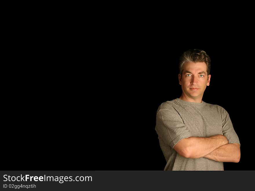 Man standing with confidence on a black background. Man standing with confidence on a black background