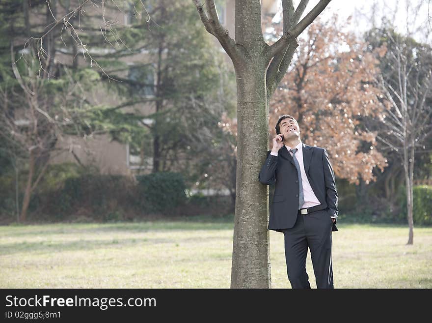 Businessman on the phone outdoors