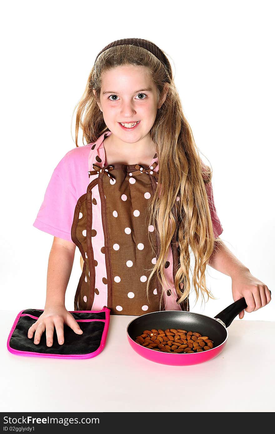 Little girl toasting almonds