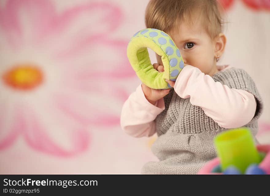 Portrait, baby in the pink, pink, child in the pink, gril in the pink, baby in the pink flowers, girl in the pink flowers, baby with toys, baby in the knitted sweatter, question in the yees, thinking baby, thinking child. Portrait, baby in the pink, pink, child in the pink, gril in the pink, baby in the pink flowers, girl in the pink flowers, baby with toys, baby in the knitted sweatter, question in the yees, thinking baby, thinking child